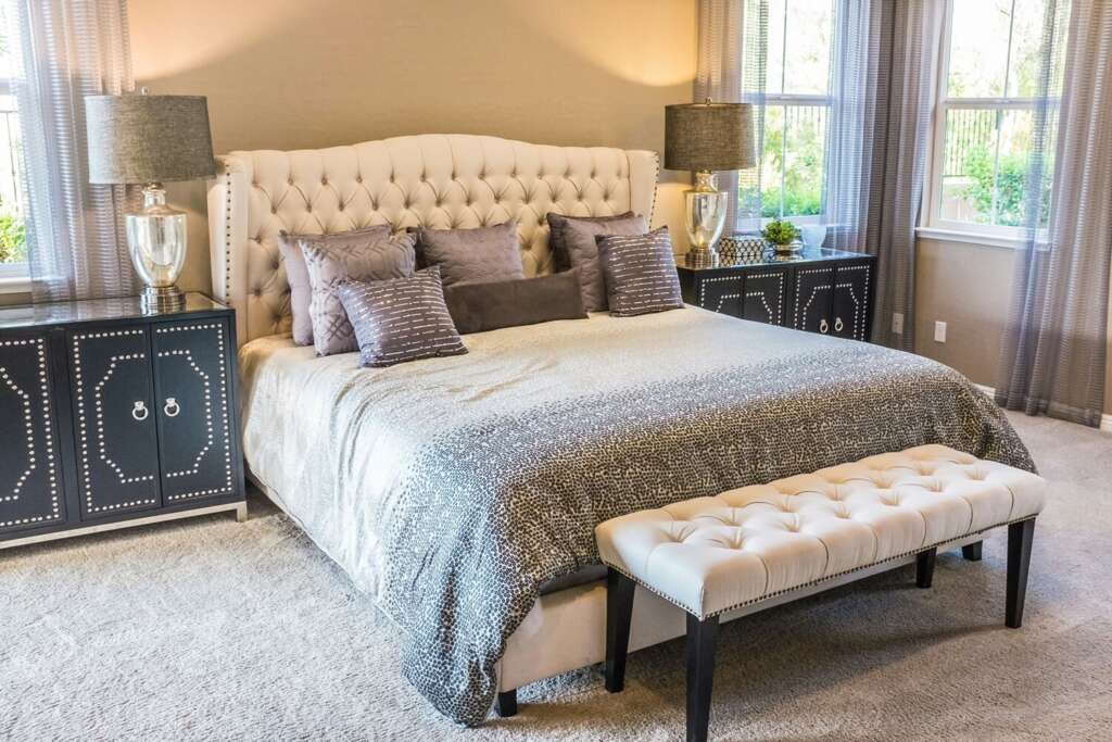 Elegant master bedroom with beige wallpaper - decoratorsnook.com